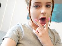 Playful redhead amateur shows off her small tits at home