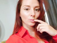 Redhead shows off her big boobs and tattoos while taking nudes