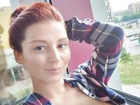 Redhead shows off her big boobs and tattoos while taking nudes