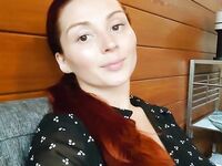 Redhead shows off her big boobs and tattoos while taking nudes