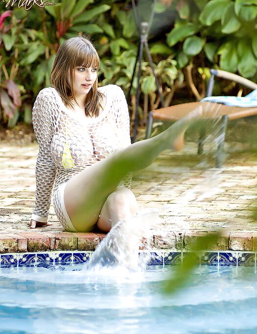 Plump solo girl Christy Marks takes of her bikini and wades into a pool